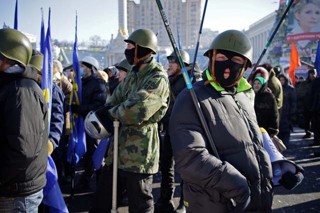 Here a member of the protestors’ Splina security group is seen sporting the old symbol of far-right party Svoboda