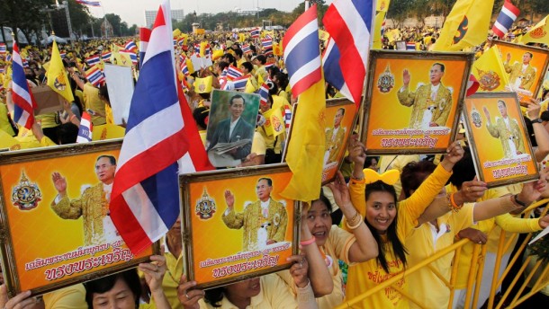 People celebrating the 85th birthday of Thailand’s King Bhumibol Adlyadej, the richest monarch in the world with a net worth in excess of $30 billion